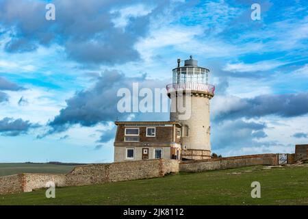 The former lighthouse of Belle Tout, now a B&B, sits precariously on the receding chalk cliffs near Beachy Head, East Sussex Stock Photo