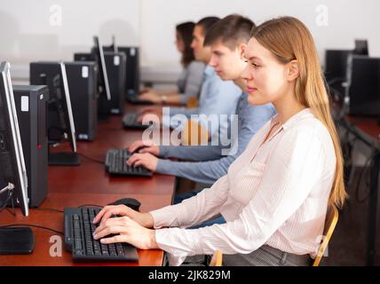 Side view of focused students working Stock Photo