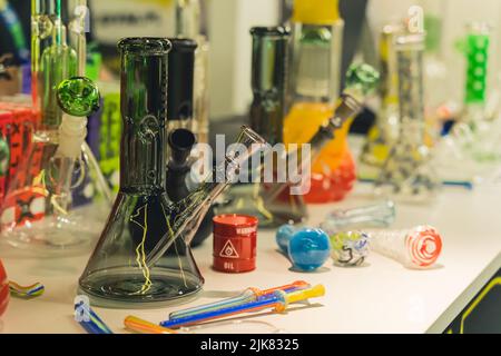05.28.2022 Warsaw, Poland. Indoor shot of colourful glass bongs in different sizes and smoking pipes. Smoking CBD as an alternative to traditional chemical medicine. High quality photo Stock Photo