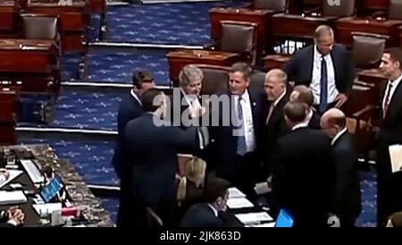 US Republican Senators created national outrage when they bumped fists after voting to hold up aid bound for military veterans suffering from burn-pit exposure.  US Sen. Ted Cruz (R-TX) was captured on CSPAN video Thursday fist-bumping US Sen. Steve Daines (R-MT.) when Republicans blocked the PACT Act, which would allow soldiers, sailors and airmen exposed to burn pits of smoldering toxic waste in combat zones to be covered by the Veterans Affairs health care system for such illnesses as cancer. (Screenshot from CSPAN) Stock Photo