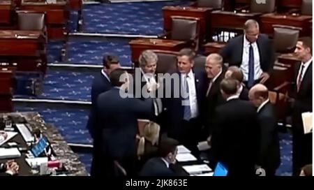 US Republican Senators created national outrage when they bumped fists after voting to hold up aid bound for military veterans suffering from burn-pit exposure.  US Sen. Ted Cruz (R-TX) was captured on CSPAN video Thursday fist-bumping US Sen. Steve Daines (R-MT.) when Republicans blocked the PACT Act, which would allow soldiers, sailors and airmen exposed to burn pits of smoldering toxic waste in combat zones to be covered by the Veterans Affairs health care system for such illnesses as cancer. (Screenshot from CSPAN) Stock Photo