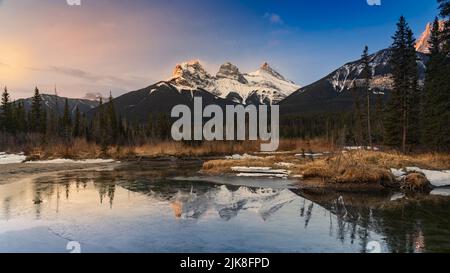 The Three Sisters mountains with reflections near Canmore, Alberta, Canada. Stock Photo