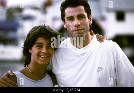 Joey Lawrence & John Travolta Film: Chains Of Gold (1994) Characters: Tommy, Scott Barnes  Director: Rod Holcomb 22 April 1991   **WARNING** This Photograph is for editorial use only and is the copyright of MCEG and/or the Photographer assigned by the Film or Production Company and can only be reproduced by publications in conjunction with the promotion of the above Film. A Mandatory Credit To MCEG is required. The Photographer should also be credited when known. No commercial use can be granted without written authority from the Film Company. Stock Photo