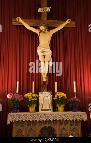 Jesus on the cross behind the altar inside Saint-Francois-de-Sales church, Laval, Quebec, Canada. Stock Photo