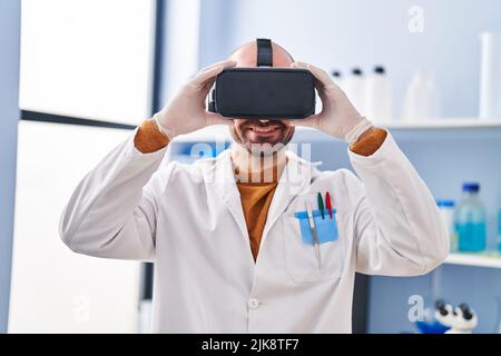 Young man scientist using virtual reality goggles at laboratory Stock Photo