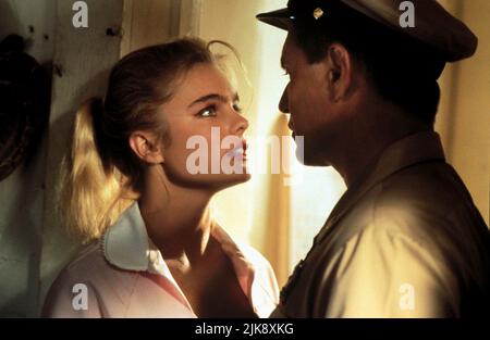 Erika Eleniak & Tom Berenger Film: Chasers (USA 1994) Characters: Toni Johnson & Rock Reilly  Director: Dennis Hopper 22 April 1994   **WARNING** This Photograph is for editorial use only and is the copyright of WARNER BROS. and/or the Photographer assigned by the Film or Production Company and can only be reproduced by publications in conjunction with the promotion of the above Film. A Mandatory Credit To WARNER BROS. is required. The Photographer should also be credited when known. No commercial use can be granted without written authority from the Film Company. Stock Photo