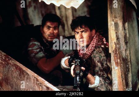 Paul Sanchez & Charlie Sheen Film: Navy Seals (USA 1990) Characters: Ramos, Lt. Dale Hawkins  Director: Lewis Teague 20 July 1990   **WARNING** This Photograph is for editorial use only and is the copyright of MGM and/or the Photographer assigned by the Film or Production Company and can only be reproduced by publications in conjunction with the promotion of the above Film. A Mandatory Credit To MGM is required. The Photographer should also be credited when known. No commercial use can be granted without written authority from the Film Company. Stock Photo