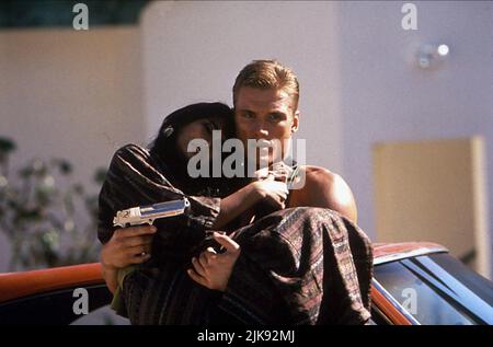 Dolph Lundgren & Tia Carrere Film: Showdown In Little Tokyo (USA 1991) Characters: Sgt. Chris Kenner, Minako Okeya  Director: Mark L. Lester 23 August 1991   **WARNING** This Photograph is for editorial use only and is the copyright of WARNER BROS. and/or the Photographer assigned by the Film or Production Company and can only be reproduced by publications in conjunction with the promotion of the above Film. A Mandatory Credit To WARNER BROS. is required. The Photographer should also be credited when known. No commercial use can be granted without written authority from the Film Company. Stock Photo