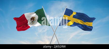 two crossed flags SWEDEN and mexico waving in wind at cloudy sky. Concept of relationship, dialog, travelling between two countries. 3d illustration Stock Photo