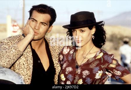 Billy Zane & Jennifer Beals Film: Blood And Concrete (1993) Characters: Joey Turks, Mona  Director: Jeffrey Reiner 13 September 1991   **WARNING** This Photograph is for editorial use only and is the copyright of SONY PICTURES HOME ENTERTAINMENT and/or the Photographer assigned by the Film or Production Company and can only be reproduced by publications in conjunction with the promotion of the above Film. A Mandatory Credit To SONY PICTURES HOME ENTERTAINMENT is required. The Photographer should also be credited when known. No commercial use can be granted without written authority from the Fi Stock Photo