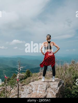 A girl on top of Falaza mountain looks at a beautiful mountain valley. Travel and tourism. Hiking High quality photo Stock Photo