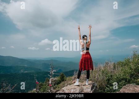 A girl on top of Falaza mountain looks at a beautiful mountain valley. Travel and tourism. Hiking High quality photo Stock Photo