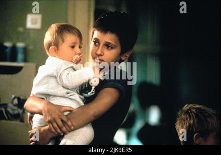 Emira Nusevic & Baby Film: Welcome To Sarajevo (1997) Characters: Emira &  Director: Michael Winterbottom 09 May 1997   **WARNING** This Photograph is for editorial use only and is the copyright of CHANNEL FOUR FILMS and/or the Photographer assigned by the Film or Production Company and can only be reproduced by publications in conjunction with the promotion of the above Film. A Mandatory Credit To CHANNEL FOUR FILMS is required. The Photographer should also be credited when known. No commercial use can be granted without written authority from the Film Company. Stock Photo