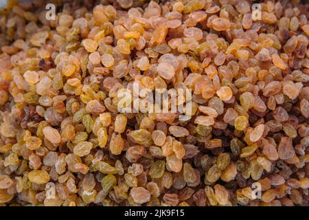 Lots of dried yellow raisins on the farmers market counter Stock Photo