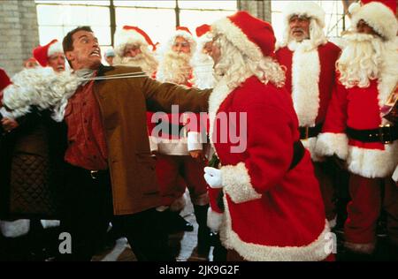 Arnold Schwarzenegger & James Belushi Film: Jingle All The Way (USA 1996) Characters: Howard Langston & Mall Santa  Director: Brian Levant 16 November 1996   **WARNING** This Photograph is for editorial use only and is the copyright of 20TH CENTURY FOX and/or the Photographer assigned by the Film or Production Company and can only be reproduced by publications in conjunction with the promotion of the above Film. A Mandatory Credit To 20TH CENTURY FOX is required. The Photographer should also be credited when known. No commercial use can be granted without written authority from the Film Compan Stock Photo