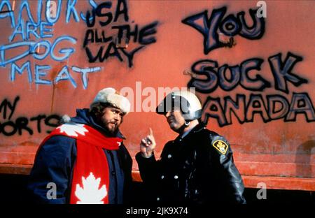 John Candy & Dan Aykroyd Film: Canadian Bacon (1995) Characters: Sheriff Bud Boomer & OPP Officer (uncredited)  Director: Michael Moore 08 June 1995   **WARNING** This Photograph is for editorial use only and is the copyright of POLYGRAM VIDEO and/or the Photographer assigned by the Film or Production Company and can only be reproduced by publications in conjunction with the promotion of the above Film. A Mandatory Credit To POLYGRAM VIDEO is required. The Photographer should also be credited when known. No commercial use can be granted without written authority from the Film Company. Stock Photo