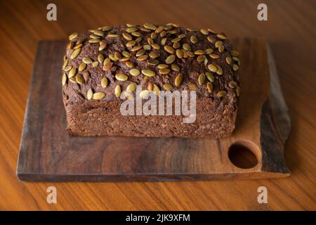 Pumpernickel or mock-rye style gluten-free seeded sourdough bread made from teff and buckwheat flour. Stock Photo