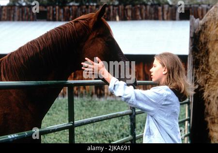 Scarlett Johansson Film: The Horse Whisperer (USA 1998) Characters: Grace MacLean  Director: Robert Redford 15 May 1998   **WARNING** This Photograph is for editorial use only and is the copyright of TOUCHSTONE PICTURES and/or the Photographer assigned by the Film or Production Company and can only be reproduced by publications in conjunction with the promotion of the above Film. A Mandatory Credit To TOUCHSTONE PICTURES is required. The Photographer should also be credited when known. No commercial use can be granted without written authority from the Film Company. Stock Photo