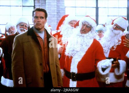 Arnold Schwarzenegger & James Belushi Film: Jingle All The Way (USA 1996) Characters: Howard Langston, Mall Santa  Director: Brian Levant 16 November 1996   **WARNING** This Photograph is for editorial use only and is the copyright of 20TH CENTURY FOX and/or the Photographer assigned by the Film or Production Company and can only be reproduced by publications in conjunction with the promotion of the above Film. A Mandatory Credit To 20TH CENTURY FOX is required. The Photographer should also be credited when known. No commercial use can be granted without written authority from the Film Company Stock Photo