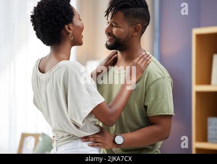 Lifes better with you in it. a young couple dancing in the living room at home. Stock Photo