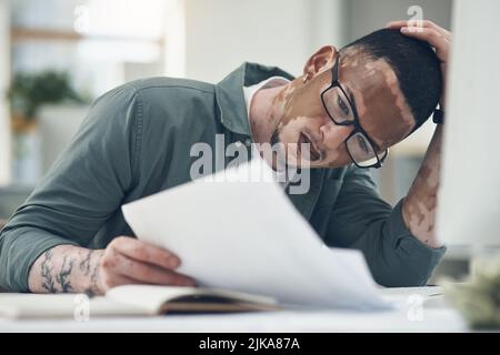 There are no secrets to success, just hard work. a young business man working in a modern office. Stock Photo