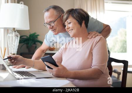 Do you think this is correct. a mature husband and wife using a laptop together. Stock Photo