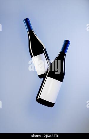 Two wine bottles mockup on blue background 3d rendering. Stock Photo