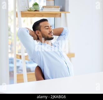 Dreaming of all my business plans. a young businessman resting in an office. Stock Photo