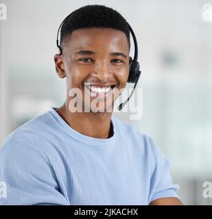 Building customer loyalty starts with exceptional customer service. Portrait of a young businessman working in a call centre. Stock Photo