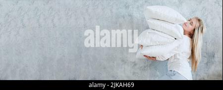 happy housewife morning chores woman pile pillows Stock Photo