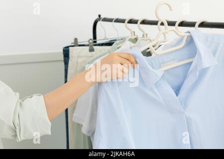 aesthetic laundry concept clothes hung on a hanger Stock Photo