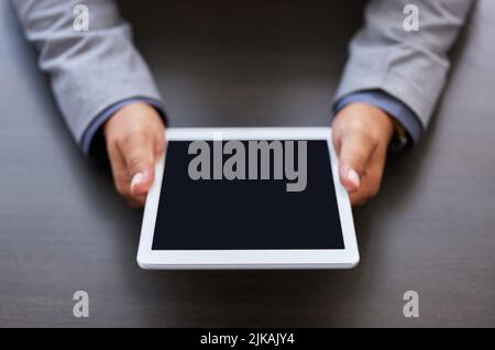 The internet has helped me to achieve great things. an unrecognizable man using a digital tablet. Stock Photo