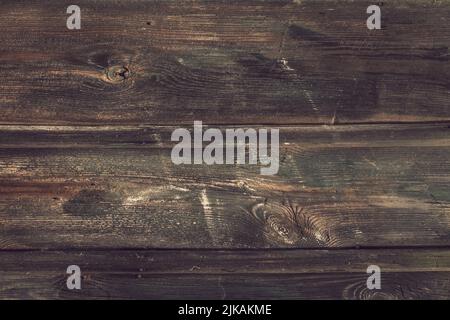 Dark brown faded wooden table, top view. Shabby horizontal boards. Abstract texture, weathered timber background. Rustic template with blank space. Wo Stock Photo