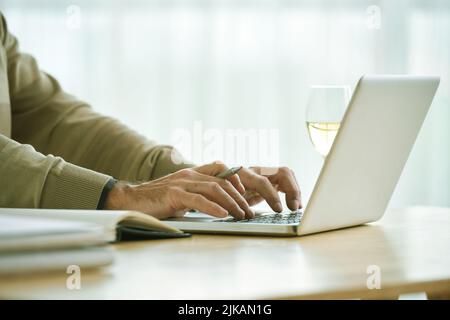 Hands on businessman working on laptop in his office Stock Photo