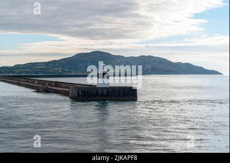 The lighthouse at the end of the harbour breakwater in Holyhead, Wales Stock Photo