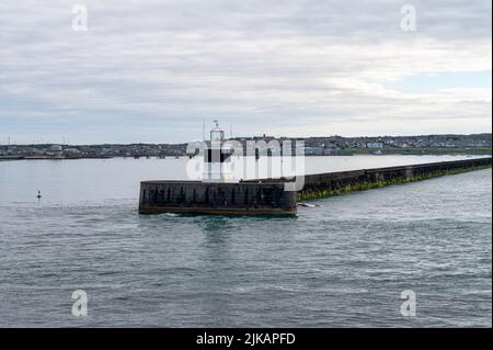 The lighthouse at the end of the harbour breakwater in Holyhead, Wales Stock Photo