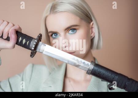 Young woman with katana sword. Stock Photo