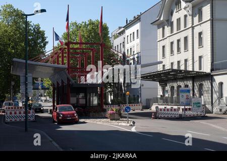 Red car passes the border checkpoint from Basel in Switzerland to Saint Louis in France, between Elsässerstrasse and Avenue de Bâle Stock Photo