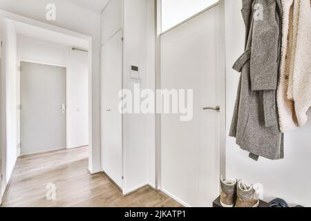 Corridor of contemporary apartment with black closets and doorway leading to terrace Stock Photo