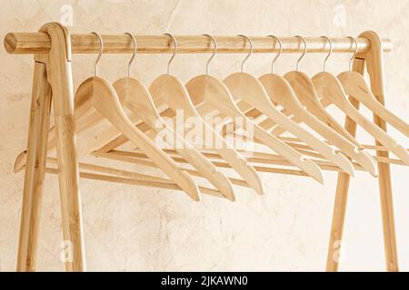 Hangers for clothes on wooden rack stand Stock Photo