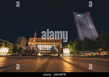 Leipzig, Germany - July 02, 2022: The city Center of the saxony metropolis at night. Gewandhaus concert hall and City Hochhaus on the Augustus square. Stock Photo