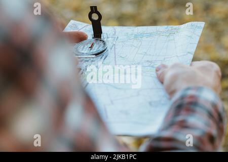 traveler lifestyle man compass map yellow grass Stock Photo