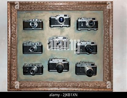 The vintage photo cameras in the frame on the wall of Fixage Cafe in Lviv Ukraine Stock Photo