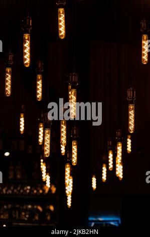 Perspective view to light bulbs, lamps hanging on wires Stock Photo