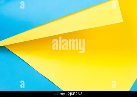 Color papers geometry flat composition background with yellow and blue tones. Colors symbols of Ukraine. Stock Photo