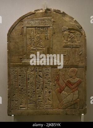 Egypt. Stele of the scribe Iry. New Kingdom. 18th Dynasty, ca. 1300 BC. The upper part depicts a sanctuary, in which King Ahmose (the founder of the 18th Dynasty) and Queen Ahmose-Nefertari are sitting on their thrones. The lower part shows the scribe Iry kneeling and saying a prayer that is inscribed in hieroglyphs in front of him. Polychrome limestone. Calouste Gulbenkian Museum. Lisbon, Portugal.