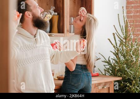 christmas fun couple enjoying dancing kitchen