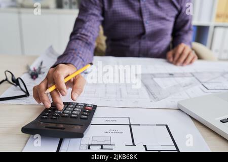 Close-up image of architect using calculator when working on construction project Stock Photo