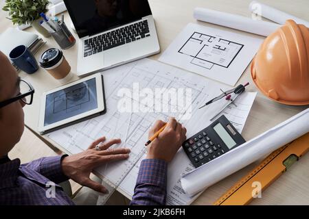 Architect working on construction project at his table Stock Photo