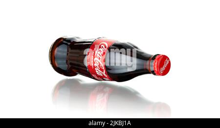 Chisinau, Moldova - July 31, 2022: Glass bottle of Coca Cola drink on white background. The drink is produced and manufactured by The Coca-Cola Compan Stock Photo